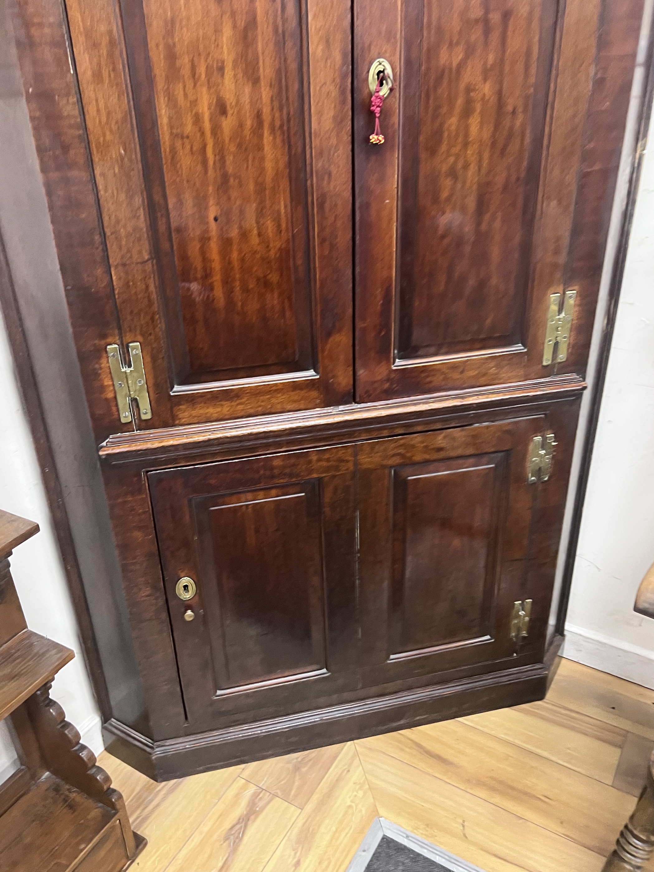 A George III mahogany standing corner cabinet, width 110cm, depth 56cm, height 228cm